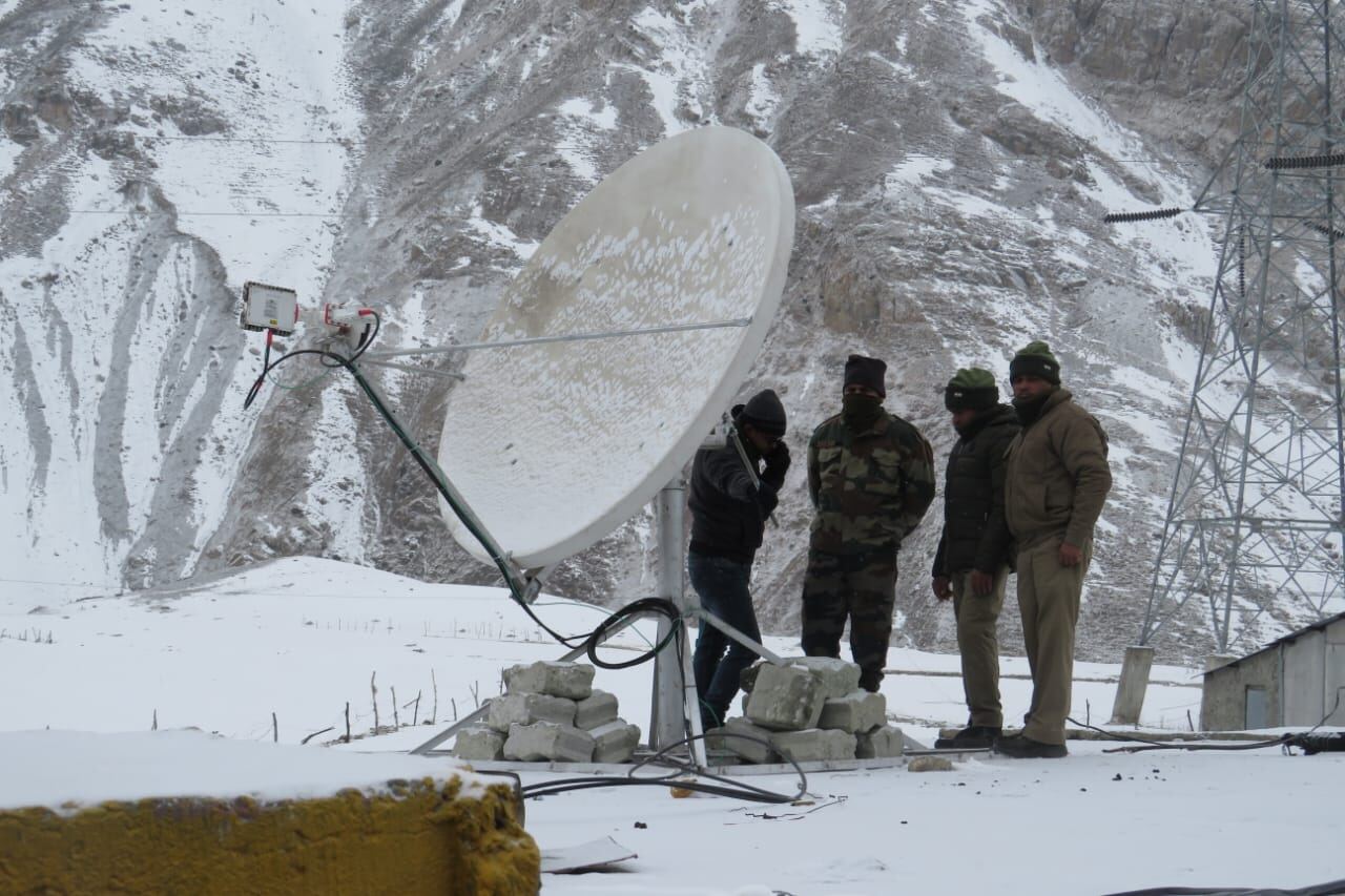 Field team with satellite terminal in snow